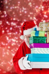 Composite image of santa claus hiding behind stack christmas gif