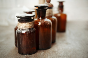 Vintage glass bottles on wooden table, closeup