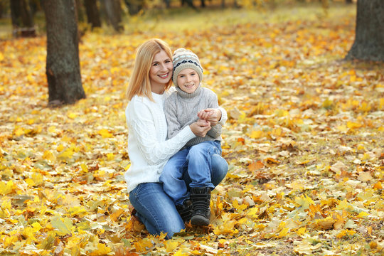 Mother and son in beautiful autumn park