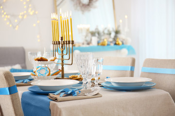 Table served for Hanukkah in living room, closeup