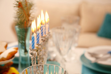 Close up view of menorah on table served for Hanukkah © Africa Studio