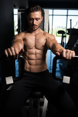 Fototapeta na wymiar Muscular Man Doing Heavy Weight Exercise For Chest