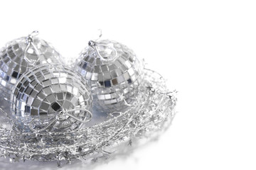 Silver mirror tile Christmas balls in a nest made of silver star wire garland