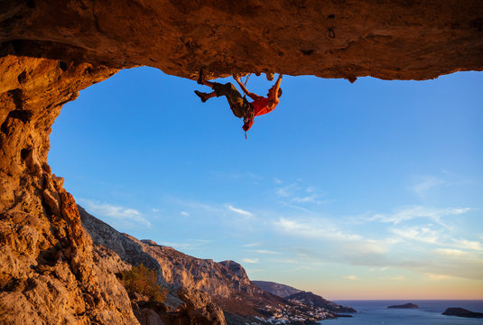 Male climber on overhanging cliff