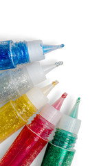 Set of colored glitter glue tubes. Isolated with clipping path