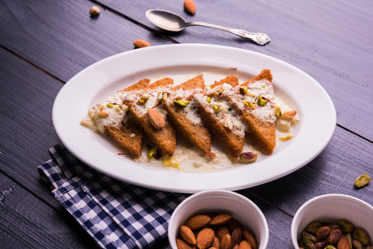 Shahi Tukda prepared - deep fried bread in ghee, garnish with sweetened cream and dry fruits. Indian sweet food