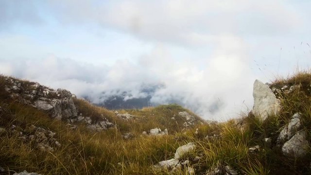 motion along the rocky terrain in autumn misty mountains
