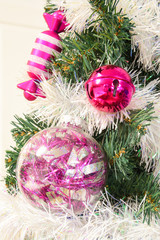 Close up of pink decorations on a Christmas tree