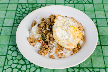 Thai street food,Rice topped fried stir basil with minced pork and fried egg on dish