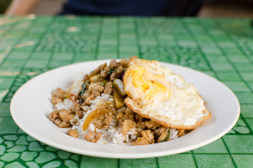 Thai street food,Rice topped fried stir basil with minced pork and fried egg on dish