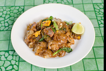 Thai street food,Fried noodle with pork on dish