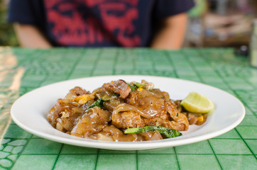 Thai street food,Fried noodle with pork on dish