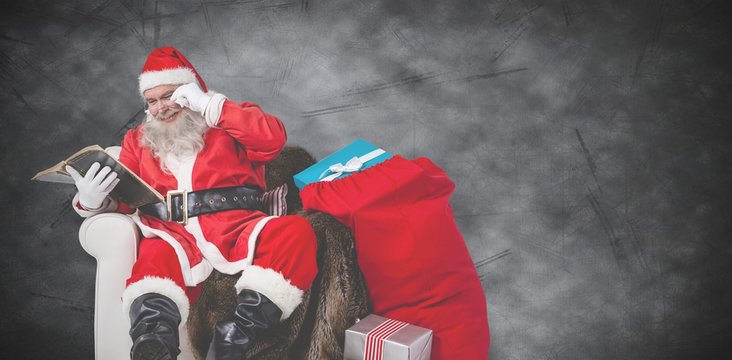 Composite image of santa reading bible with sack of christmas pr