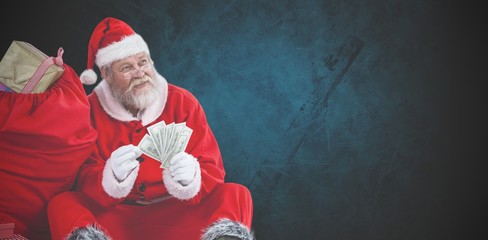 Composite image of santa claus sitting by sack full of gifts cou