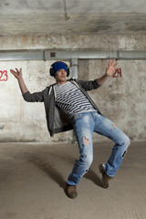 Man break dancing on wall background