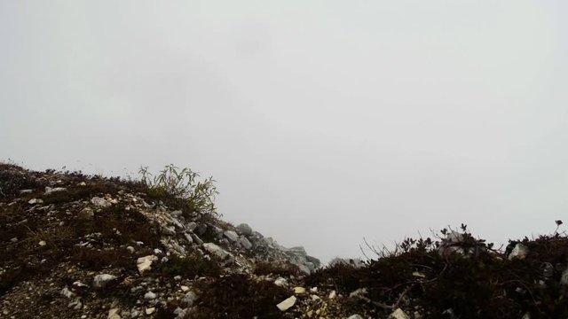 motion along the rocky terrain in autumn misty mountains