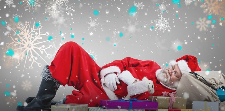 Composite image of santa claus resting beside christmas gifts
