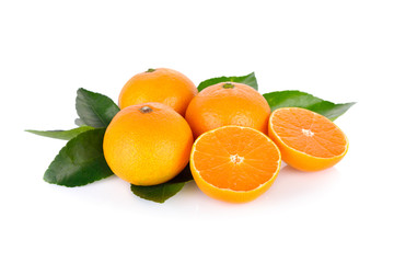 whole and cut ripe orange with leaf on white background