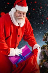 Composite image of santa claus putting christmas presents in chr