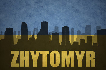 abstract silhouette of the city with text Zhytomyr at the vintage ukrainian flag