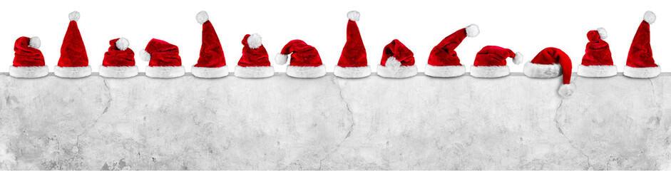 red white christmas santa hats on concrete wall empty billboard isolated on white background
