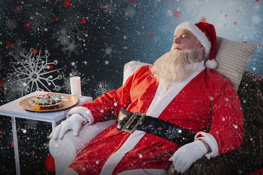 Composite image of santa claus relaxing on sofa