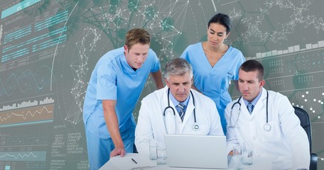 Composite image of team of doctors using laptop at desk