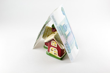 House and one thousand rubles money on a white background