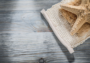 Starfish wisp of bast on wooden board healthcare concept