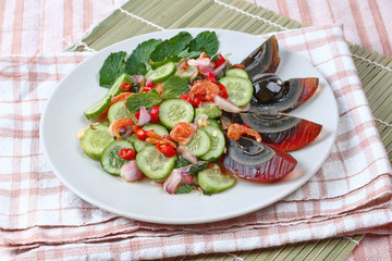 Close up spicy cucumber salad with dried-shrimp and  preserved e