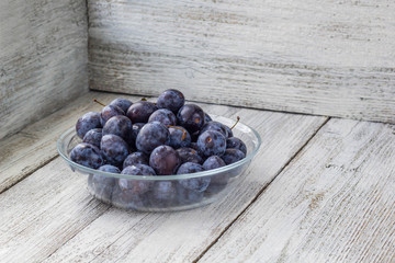 Fresh plums in cup
