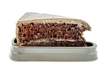 Piece of chocolate cake on white isolated background.