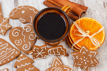 Fresh gingerbread, cup of coffee and spices on old wooden background, christmas time