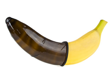 Black condom and banana isolated on white background. Safe sex c