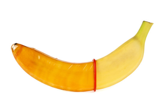 Red condom and banana isolated on white background. Safe sex con