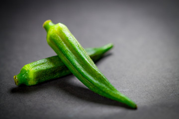 Close up fresh okra on black background.