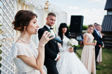 Master of ceremony speech on microphone background wedding coupl