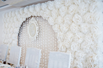 Obraz na płótnie Canvas Wedding arch of white decor flowers and frame with abbreviation
