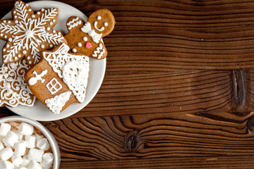 Christmas gingerbread, spruce branches on wooden background top view