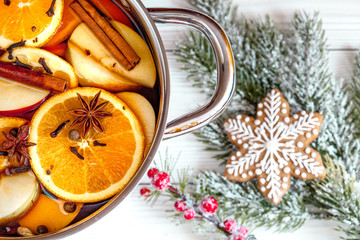 preparation of mulled wine in pot wooden background top view