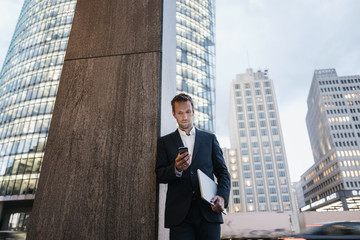 Man with smartphone, Potsdamer Platz, Berlin, Germany
