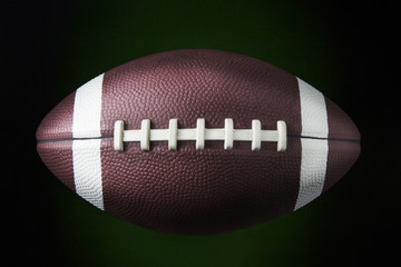 american football ball / portrait of a american football ball in dark background