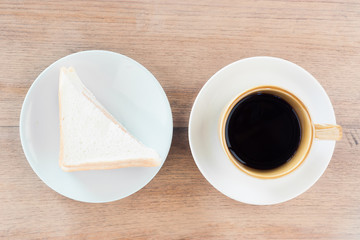 sandwich and coffee cup on brown wood texture