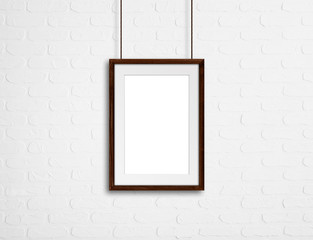 Brown  wooden photo frame, hanging on bricks wall, interiors decor mock up