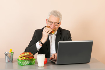 Senior business man eating bread