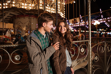 Fototapeta na wymiar Nice couple in amusement park