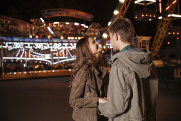 Fototapeta na wymiar Laughing couple in amusement park