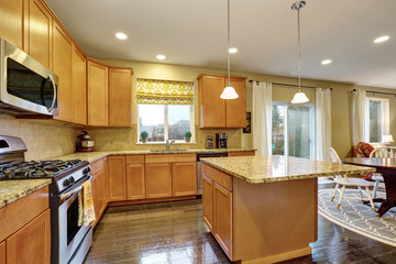 Fototapeta na wymiar Spacious kitchen room with gleaming hardwood floor