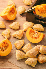 Pumpkin puffs (triangles) on brown wooden background.