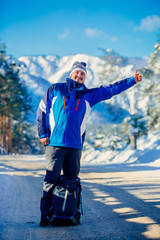 the tourist in winter in the mountains , standing on the highway